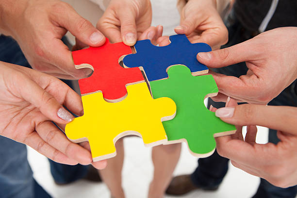 istock Businesspeople Joining Puzzle Pieces 507121873