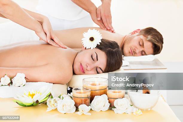Couple Receiving Massage At Spa Stock Photo - Download Image Now - Couple - Relationship, Massaging, Adult