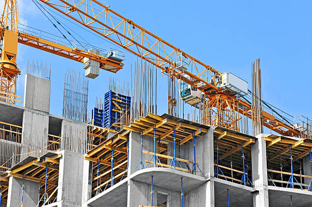 Crane and construction site Crane and building construction site against blue sky construction site stock pictures, royalty-free photos & images