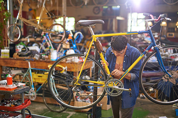 istock Female bicycle mechanic repairing bicycle 507122954