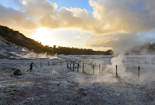 The Solfatara is a shallow volcanic crater with steam with sulfurous fumes ( at Pozzuoli, near Naples).