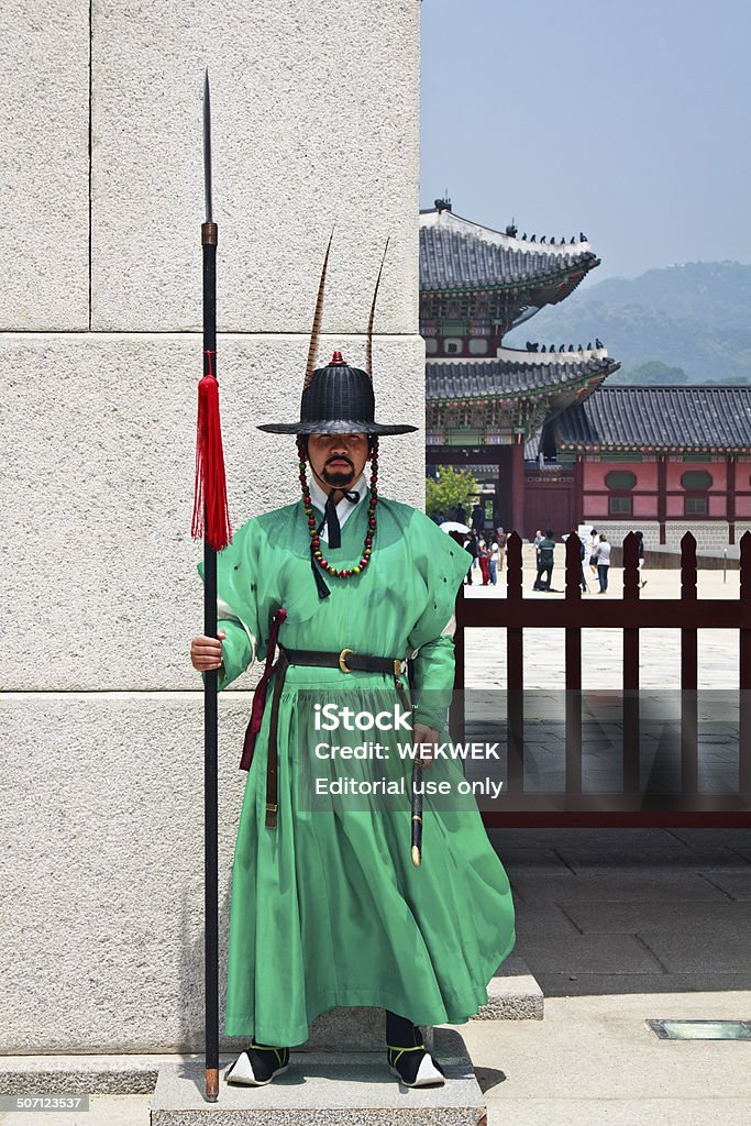 Royal guard standing at the main gate Seoul, South Korea - May 30th, 2013: Royal guard holding spear standing at the main gate of the Gyeongbokgung Palace, Gwanghwamun. Traditional Clothing Stock Photo