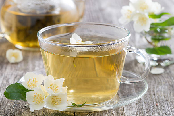 istock kettle and a cup of green tea with jasmine, close-up 507126127