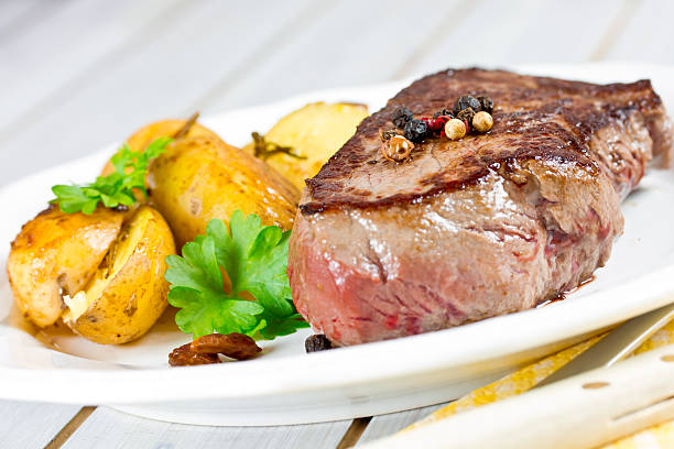 istock steak with potato wedges 507126469