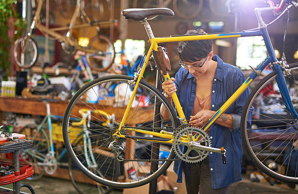 istock Female bicycle mechanic repairing bicycle 507140190