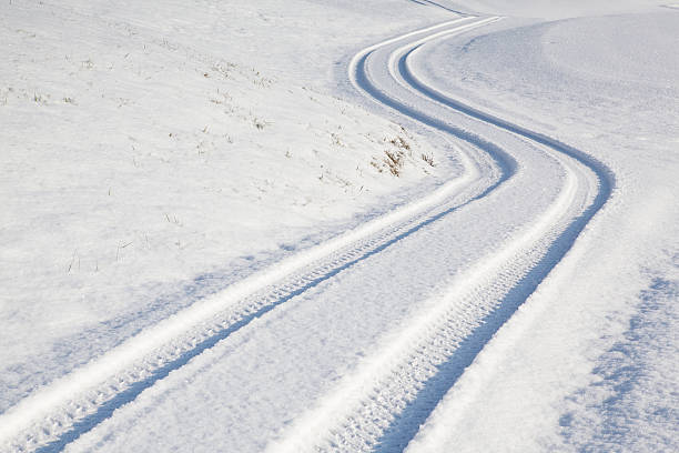 istock Car tire track on winter road 507141286