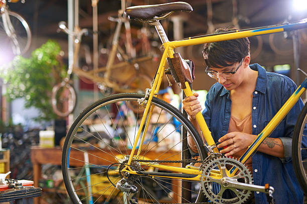 istock Female bicycle mechanic repairing bicycle 507142130