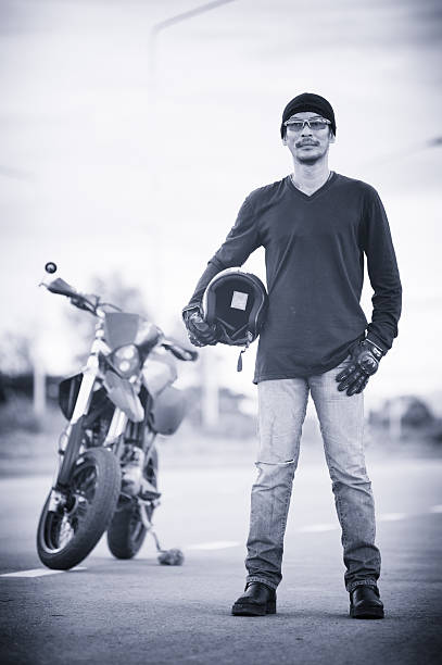 istock portrait of man biker standing on road with motorcycle 507143214