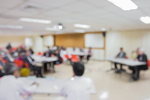 istock Blur audience sitting in conference  room with screen 507144234