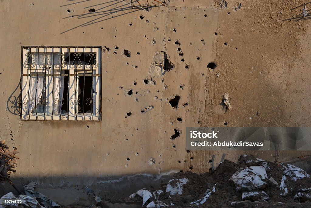 Gun bullet-riddle room and window Window with bullet hole on war. Wall - Building Feature Stock Photo