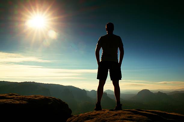 istock Alone hiker in black pants  stand on rock, morning valley 507146500