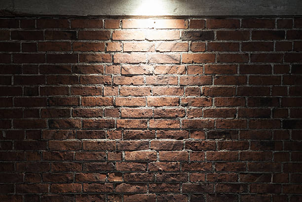 istock Grungy dark red brick wall with spotlight, texture 507147652