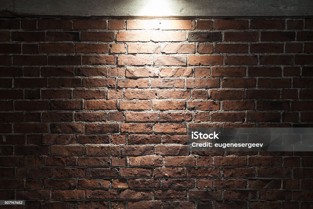 Grungy dark red brick wall with spotlight, texture Grungy dark red brick wall with spotlight, background photo texture Brick Wall Stock Photo