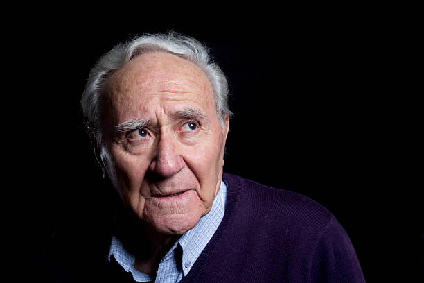 istock senior tranquil and pensive thinking portrait isolated on black 507148880