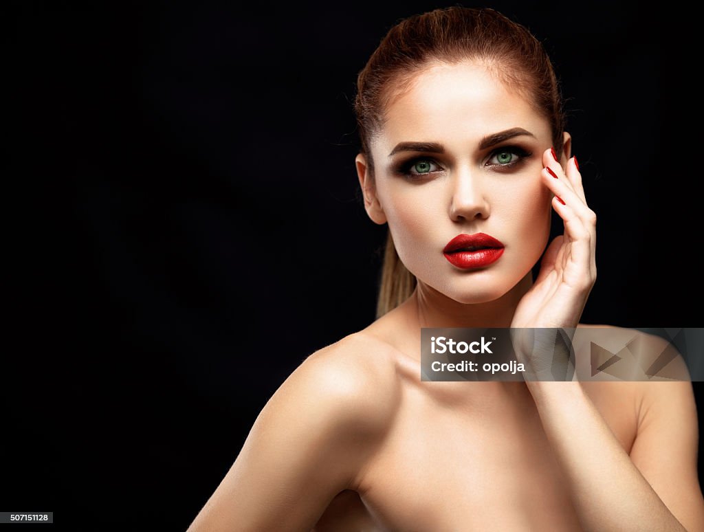 Beauty Model Woman. Beautiful Professional Makeup. Red Lips Beauty Model Woman with Long Brown Wavy Hair. Healthy Hair and Beautiful Professional Makeup. Red Lips and Smoky Eyes Make up. Gorgeous Glamour Lady Portrait. Adult Stock Photo