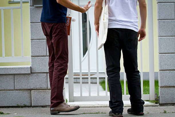 Door sales Two men are waiting outside a house to do business. door to door salesperson photos stock pictures, royalty-free photos & images