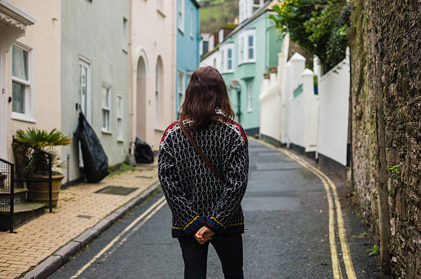 istock Young woman walking in small village 507155852