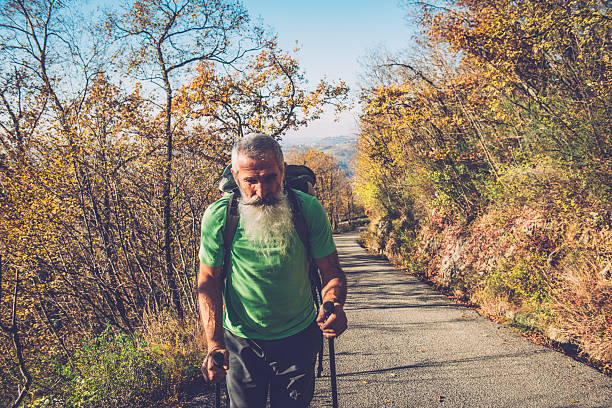 felice anziana caucasica parapendio camminare sulla strada di montagna, alpi, europa - outdoors nature paragliding autumn foto e immagini stock