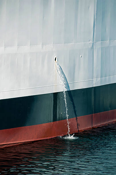 istock Ballast water pouring from ship's hull into lake 507159187