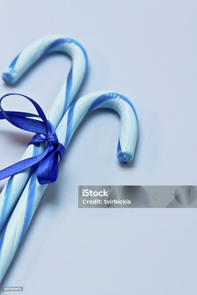 Blue Candy Canes 2 blue candy canes tied with blue ribbon on blue background Award Ribbon Stock Photo