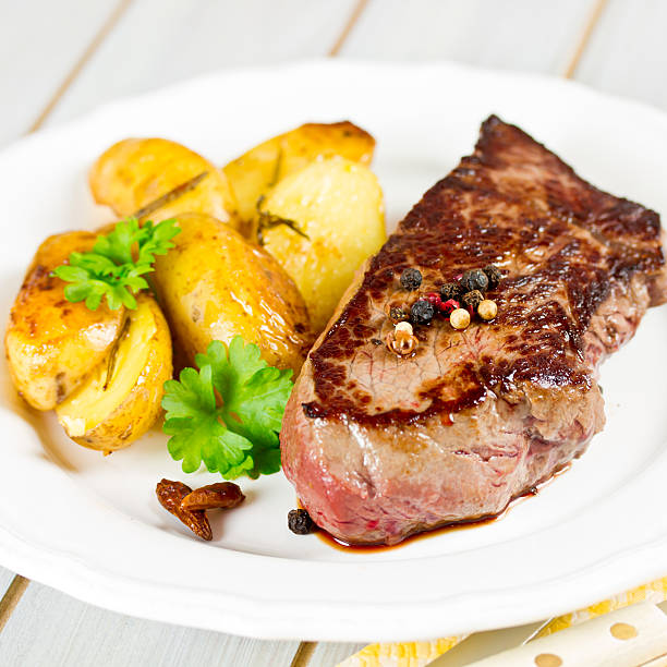 istock steak with potato wedges 507161911