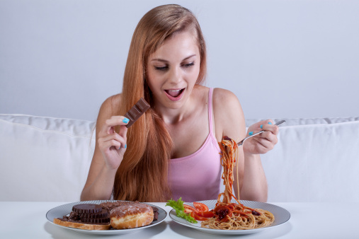 Girl suffering from bulimia eats dinner with dessert