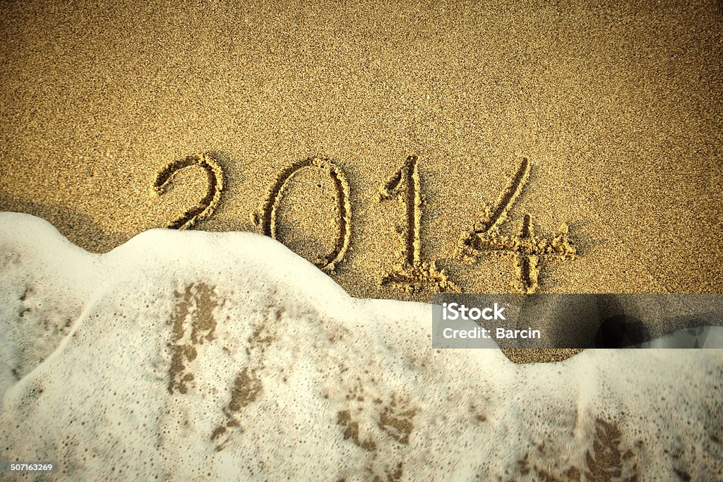 Year 2014 2014 written in sand with waves 2014 Stock Photo