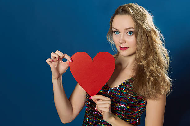 istock St Valentine day woman blue background red heart 507167748
