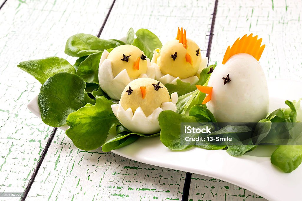 Easter appetizer of boiled eggs Easter appetizer of boiled eggs in the form hen with chicks on lettuce leaves Animal Stock Photo