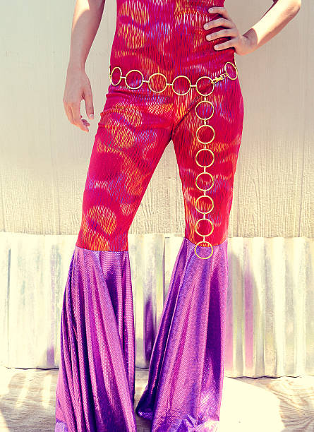 Bell Bottoms Bottom half of Woman wearing a disco jumpsuit costume.  Shot in Cantonment, Florida. flare pants stock pictures, royalty-free photos & images