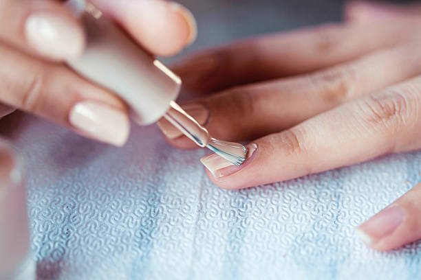 cuidados hermosa mujer uñas con crema clavo - manicura fotografías e imágenes de stock