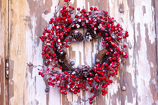 A beautiful Christmas wreath on an old distressed whitish door in Santa Fe, NM.