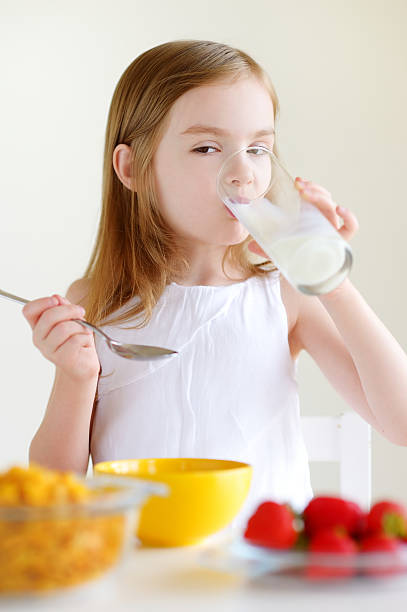 istock Little girl eating cereal with milk 507171888