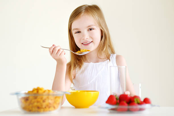 istock Little girl eating cereal with milk 507171960