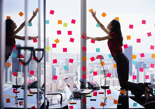istock Busy Person Attaching Many Sticky Notes On Large Window 507174052
