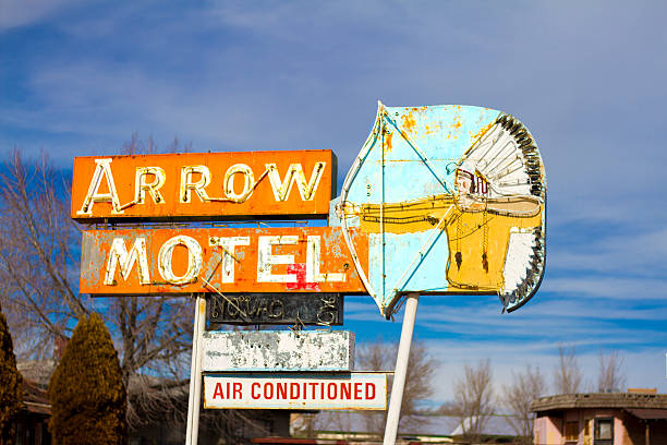 Española, NM, USA - January 23, 2016: A vintage sign for a defunct motel featuring a Native American with a bow and arrow. Española is just north of Santa Fe, NM.