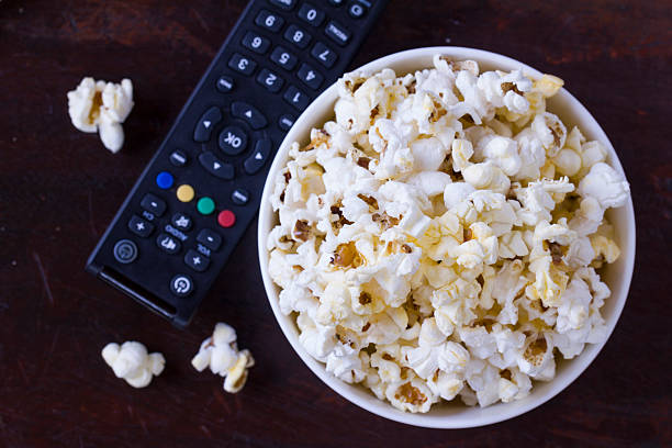 istock Popcorn with TV remote controler 507175282