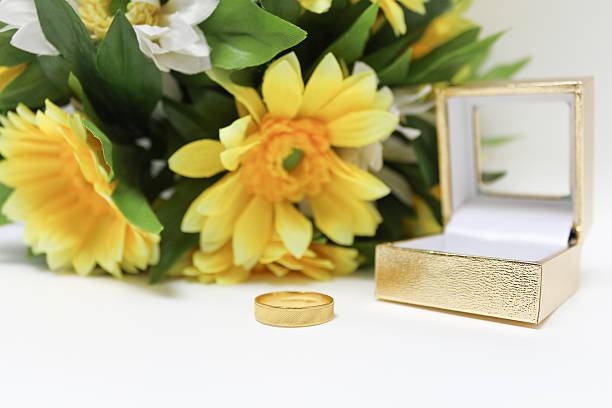 istock Gold Ring and sunflower bouquet on white background 507175490