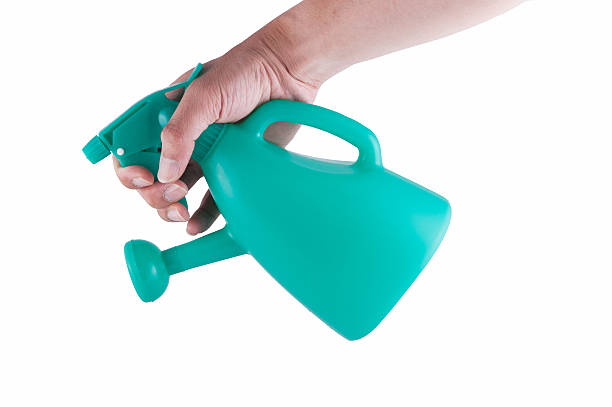 istock hand holding watering can isolated on white background 507175798