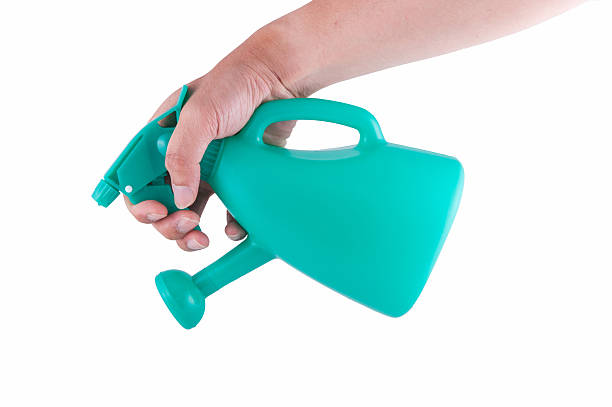 istock hand holding watering can isolated on white background 507175828