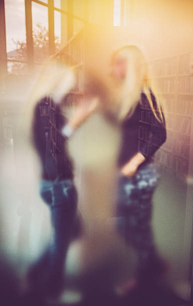 istock Two Women Behind Hazy Glass in Library 507179576