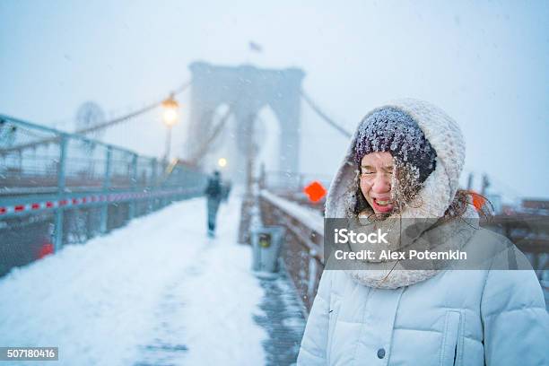 Teenager Girl At The Brooklyn Bridge Under Snowfall Stock Photo - Download Image Now