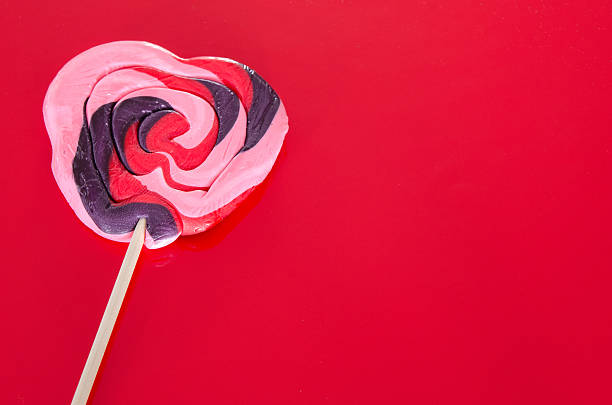 istock Pink, red and purple heart shaped candy sucker 507182424