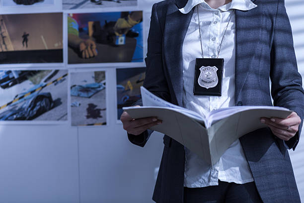 Reviewing files and documents Police woman is reviewing files and documents police station stock pictures, royalty-free photos & images