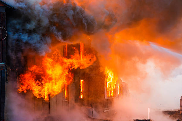 Fire in a house Fire in an old wooden house extinguishing photos stock pictures, royalty-free photos & images