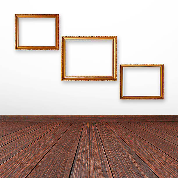 istock Three golden picture frames on the wall inside the room 507188259