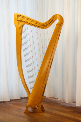 A celtic harp with strings standing. Ready to play.