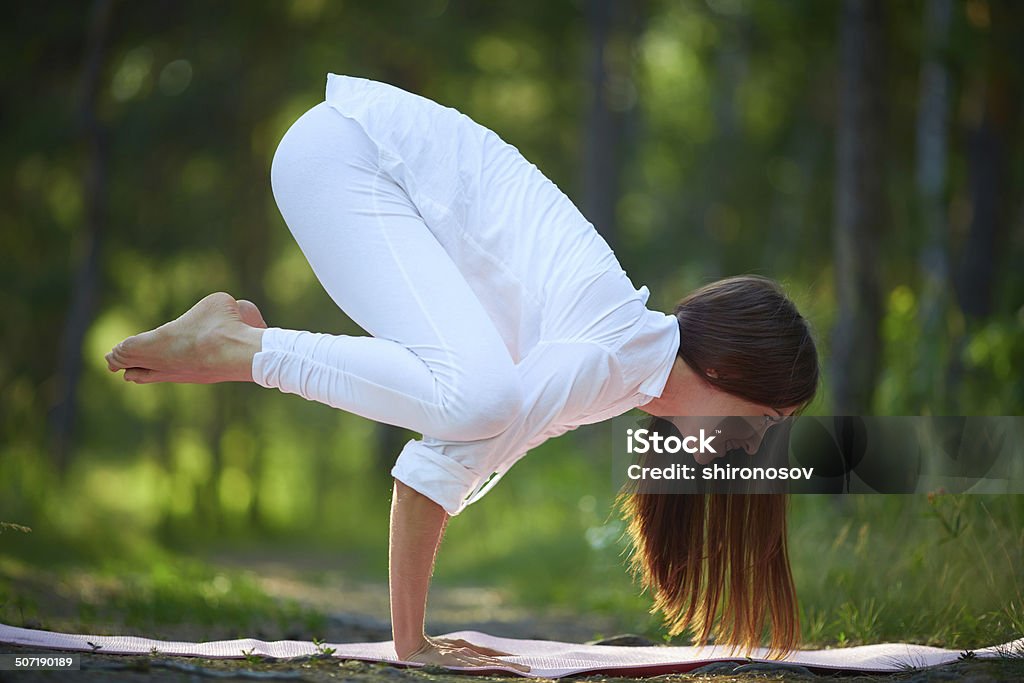 Standing on palms Photo of skilled female standing on palms in natural environment Acrobat Stock Photo