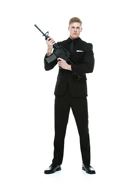 istock Businessman holding machine gun 507190333