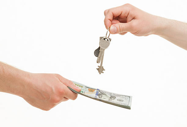 istock Business people exchanging keys and money 507202860